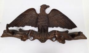 19th-century Black Forest walnut carved coat rack in the form of an eagle displayed, on branch, with