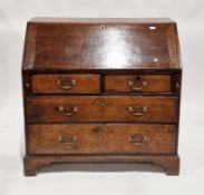 George III oak bureau, the sloping fall front opening to an interior fitted with drawers and