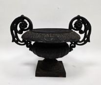 Victorian-style cast iron urn of squat campana form, with acanthus leaf scrolling handles, 31cm high