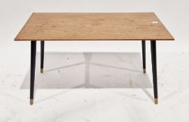 Mid-century teak coffee table, the rectangular top on ebonised turned tapering legs with brass caps,