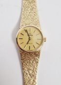 Lady's 9ct gold Omega De Ville wristwatch, the champagne coloured dial with raised baton hour