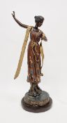 V Bronzed spelter figure of a lady, her dress and shawl with gilt and coloured decoration, on a