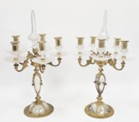 Lot Withdrawn Pair of gilt metal and glass four-branch candelabra in the Rococo manner, with faceted
