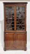 19th-century mahogany standing corner cabinet, the upper section with twin astragal-glazed doors