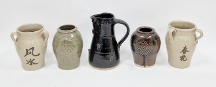 Jeremy Leach (b.1941), a stoneware pitcher of tapered form with ribbed strap handle, the body with