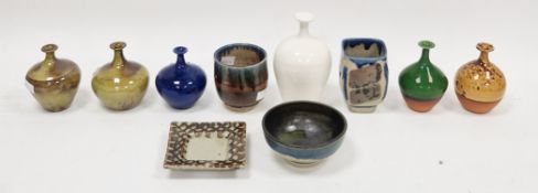 Six studio pottery bottle vases by Russell Akerman, comprising an oviform white glazed example, 16.