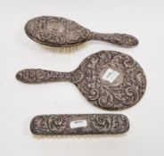 Silver-backed dressing table set viz:- mirror, hairbrush and clothes brush, all with green man mask,