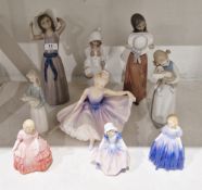 Group of Lladro figures including: a girl with lamb, a girl standing with wide brimmed hat,
