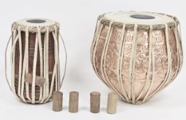 Indian tabla set comprising a copper bayan base drum and wooden dayan treble drum, with skin