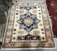 V Cream ground rug with central geometric medallion on elephant foot gul and geometric shape pattern