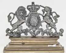 Victorian doorstop in the form of a pewter Royal Coat of Arms (a/f) on a stepped bronze base, 24cm