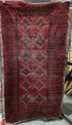 Eastern red ground rug with two rows of six geometric medallions on a geometric shape pattern field,