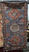 Eastern midnight blue ground rug with three geometric medallions on a floral field, multiple