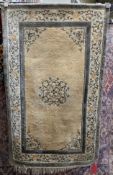 Chinese cream ground superwash rug with central geometric motif, floral spandrals and single