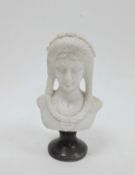 Marble bust of a classical woman, with flowers in her hair, on a black socle base, 26cm high