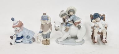 Collection of Lladro figures, comprising: a pair of Inuit children riding a polar bear, another