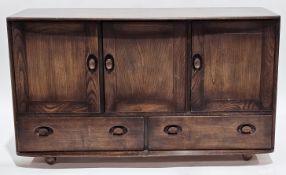 Mid-century Ercol dark elm and beech sideboard, model 468, comprising three cupboard doors over