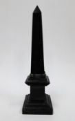 Black marble obelisk in the Grand Tour style, on a plinth base, 41cm high
