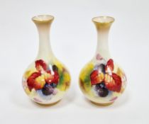 Pair of small Royal Worcester bottle vases painted by Kitty Blake, printed puce factory marks,