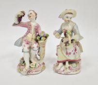 Pair of Bow porcelain figures of vintners, circa 1760, modelled seated holding a basket of grapes,