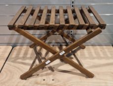 Early to mid-century wooden folding luggage rack with slatted top, label to underneath reads '