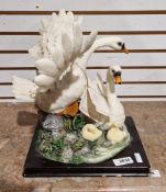 An Academy resin sculpture of two swans with signets, 29cm high