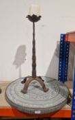 Hand forged cut iron candle holder with bracket feet, 66cm high, together with a North African brass