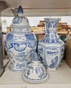 V Two modern Chinese ceramic jars with covers, both having blue and white decoration, the tallest