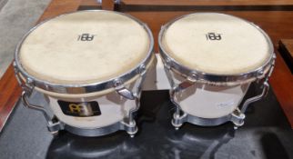Pair of Meinl bongo drums, each with buffalo skin heads and white plastic and chrome-plated