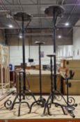 Two wrought iron jardiniere stands, tallest 107cm high together with three wrought iron candle