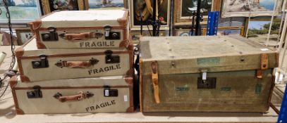 Set of three vintage-style graduating canvas-covered and leather-bound suitcases, the lids