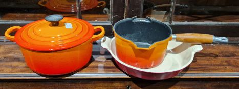 Le Creuset orange cast iron lidded cooking pot, size B, a Le Creuset orange cast iron saucepan, size
