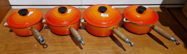 Set of four Le Creuset cast iron orange saucepans with lids, sizes 20, 18 x 2 and 16 (4)