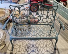 Metal garden bench with a dark green finish, pieced scrolling design to back and seat, 94cm high x