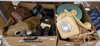 Mixed lot of collectable items including two wood telephones, a metal cake tin, gas mask, books,