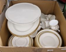 Collection of mainly white dinner and tea ware with gold-coloured rims, including Wedgwood, Spode,