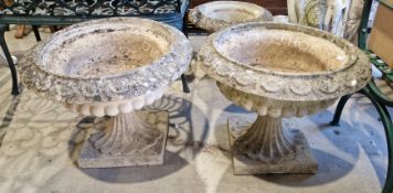 Pair of Sanford Stone garden urns of circular tazza urn form, on square bases, 52cm high x 64cm