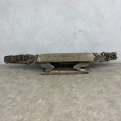 A 20th century African tribal hardwood ceremonial bench of abstract figural form with carved