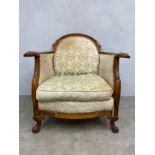 A 19th century walnut bergere armchair in the French Louis XV style having a shaped back and arms