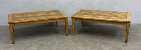 A pair of low coffee or side tables with plank tops raised on tapered supports. H.33 W.87 D.58cm