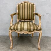 A 19th century French fauteuil armchair with painted and distressed back and arms over the striped
