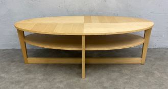 A contemporary birch Ikea Vejmon coffee table with oval figured top raised on flat cruciform