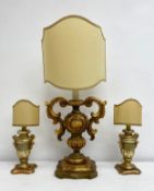 A set of three Italian Rococo style gilt and painted table lamps of urn form with shaped shield
