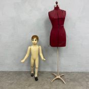 An early 20th century hand painted child's mannequin with articulated arms together with a vintage