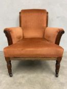 A Victorian mahogany framed armchair with scrolled back and arms over the square stuffover seat