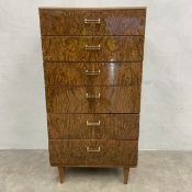 A 1960s burr elm chest of six figured drawers raised on tapered circular section supports. H.126 W.