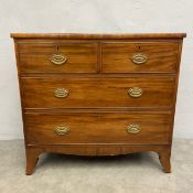 A Georgian mahogany chest of two short over two long figured drawers raised on swept bracket