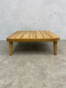 A vintage teak coffee table with square plank top raised on tapered supports by Cox & Cox with