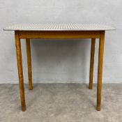 A mid-century kitchen side table with checked formica top raised on straight supports. H.75 W.81 D.