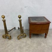 A pair of brass and iron fire dogs in the classical style and a 19th century mahogany commode. H.